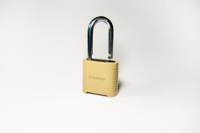 gold padlock on white surface